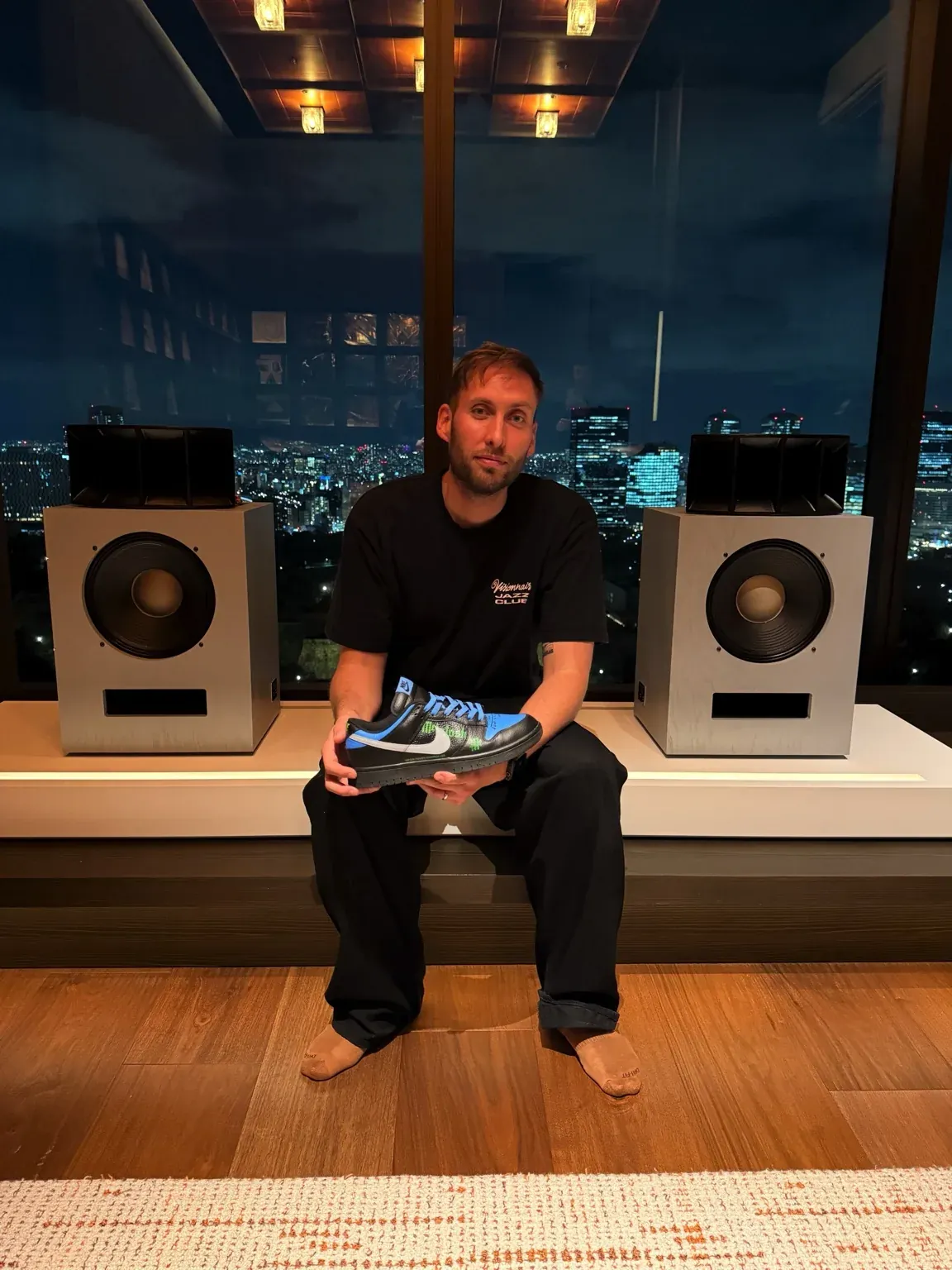 Hugo Lahutte in Osaka, listening to hi-fi in front of Klipsch Ojas speakers